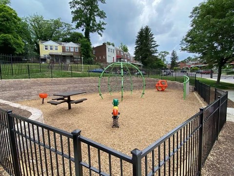 A playground with a swing set and a sandbox.