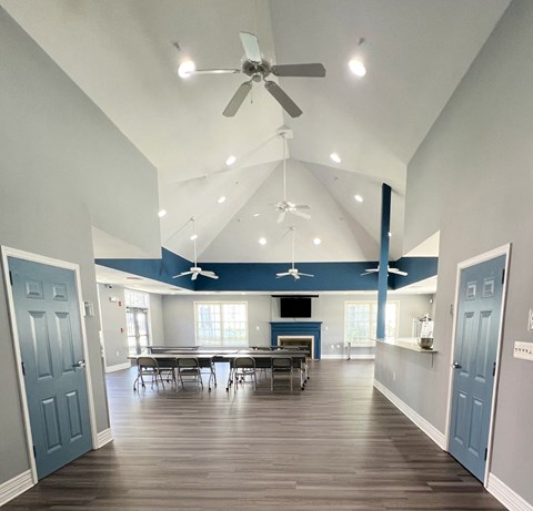 A spacious room with a dining table and chairs.