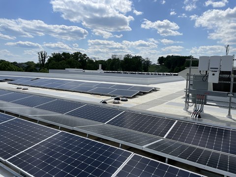 A large array of solar panels are installed on a roof.