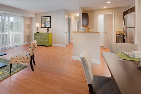 A dining room with a table and chairs.