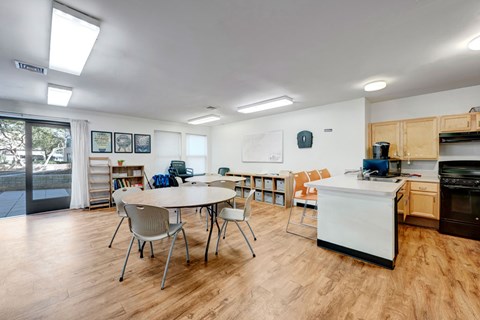A kitchen with a table and chairs in the middle of the room.