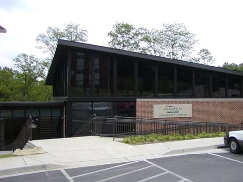 A building with a sign that says Greenpeace Community Center.