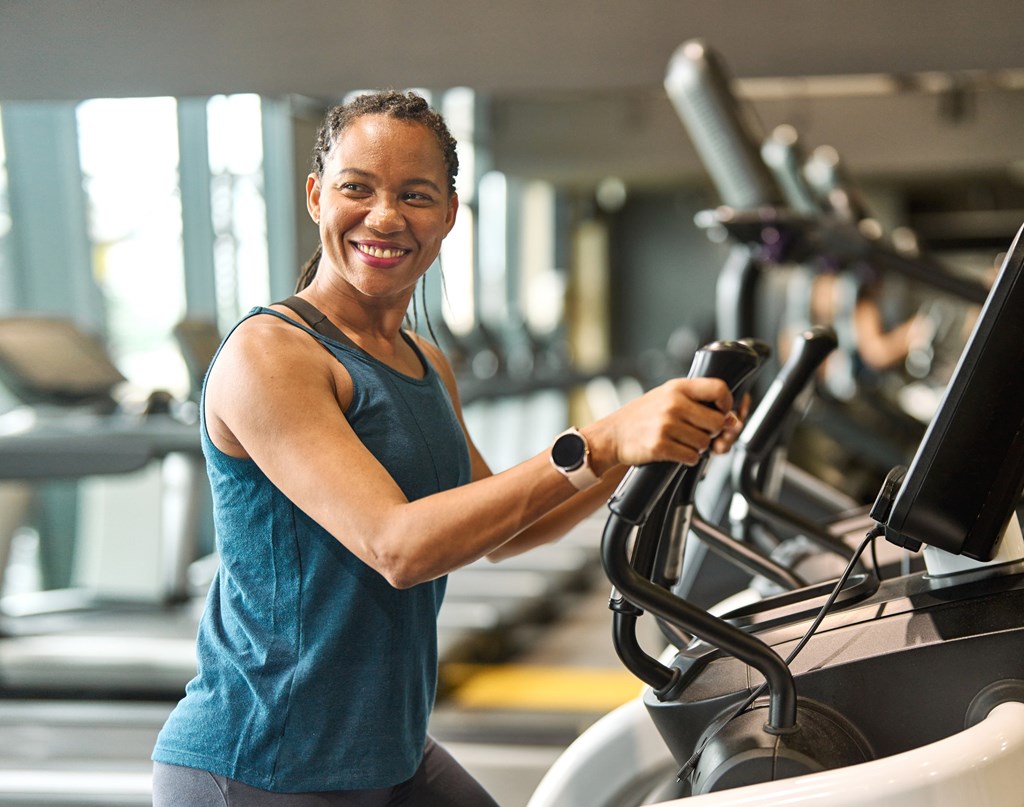 A woman is working out on a treadmill in a gym.