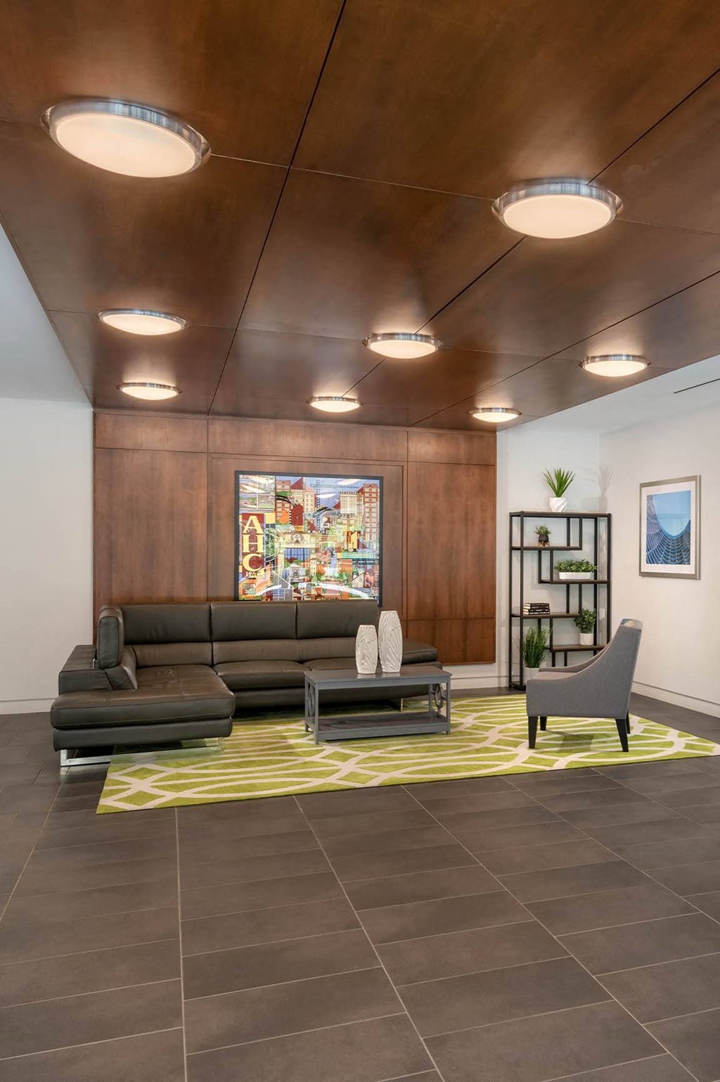 a lobby with couches and chairs and a painting on the wall