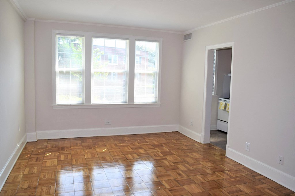 A room with wooden floors and a white door.