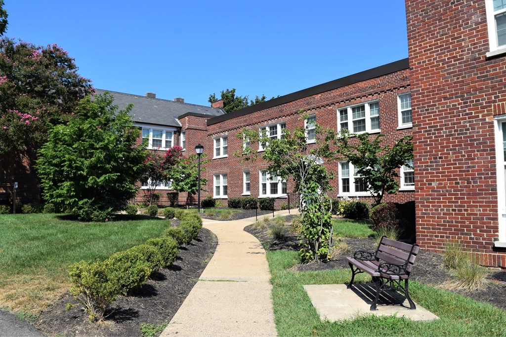 A brick building with a bench in front of it.
