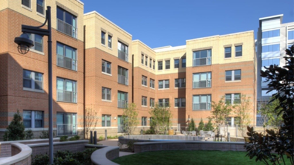 A modern building with a curved walkway in front.
