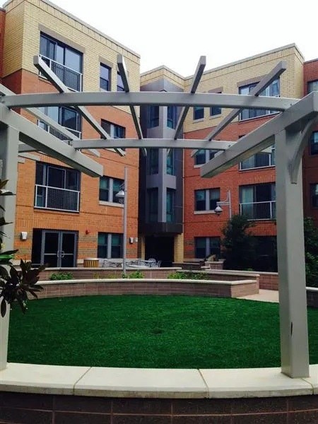 A modern building with a green lawn in front.
