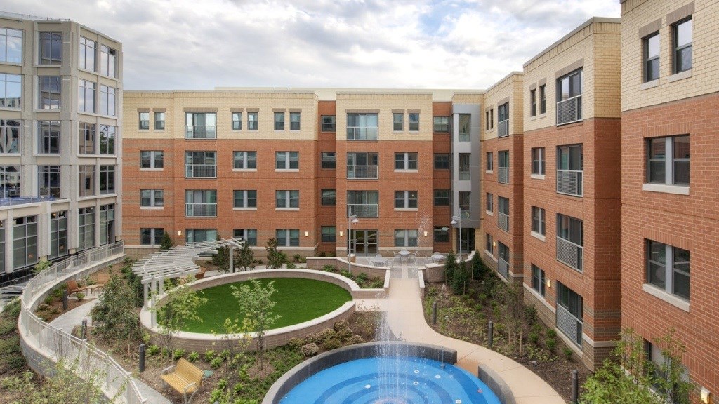 A large building with a pool in the middle of a courtyard.