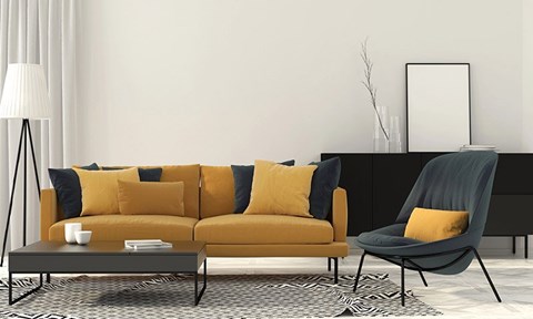 A modern living room with a yellow sofa and a black chair.