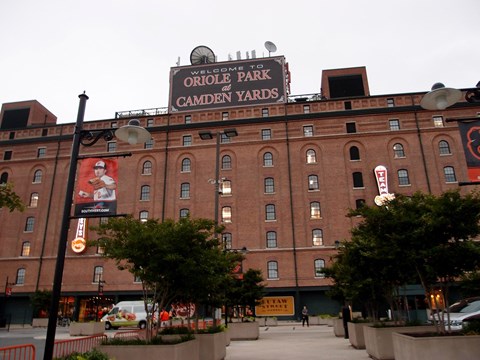 A large brick building with a sign that says Oriole Park at Camden Yards.