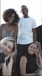 Three people are standing together and taking a selfie.