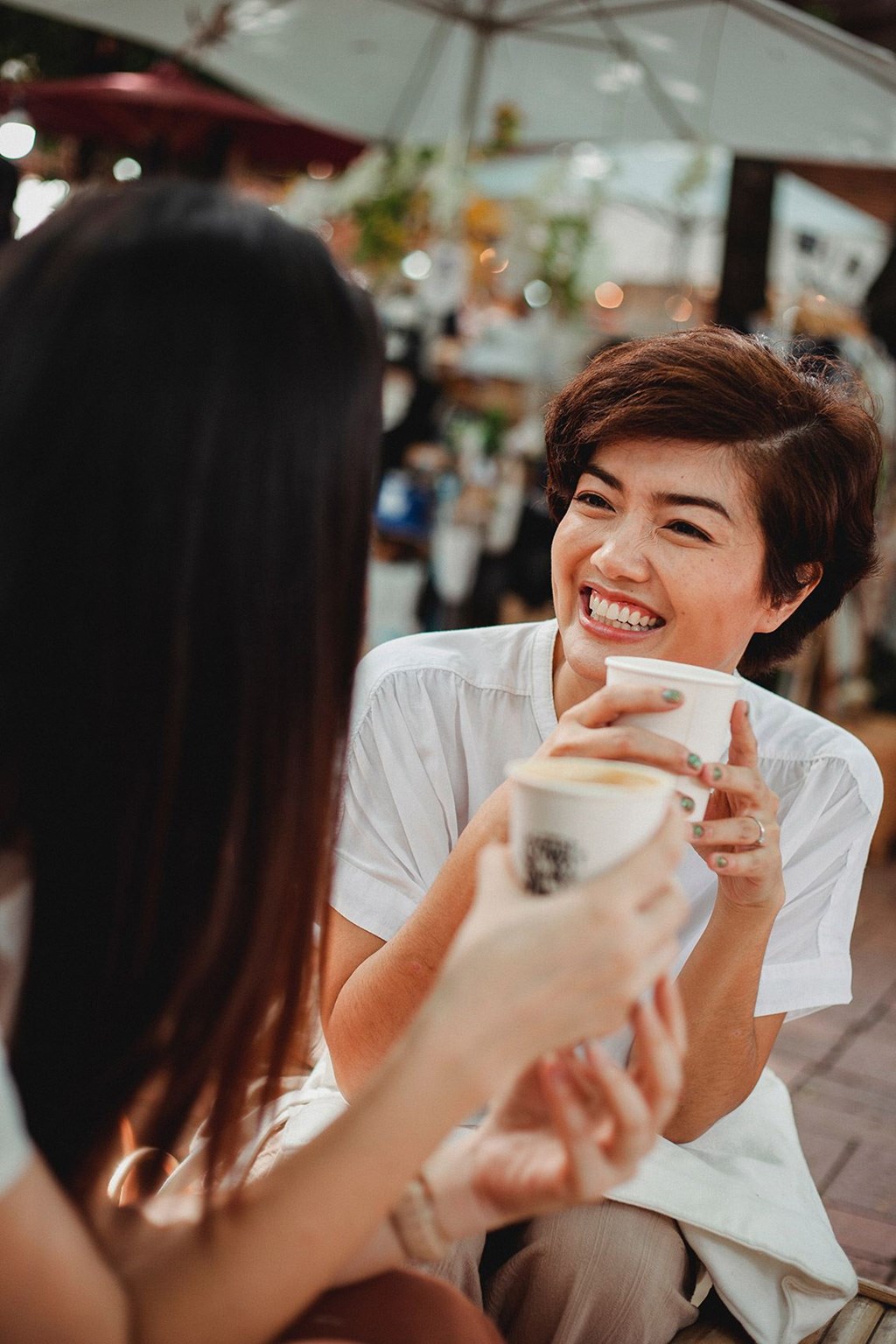 Two women having a conversation over a cup of coffee.
