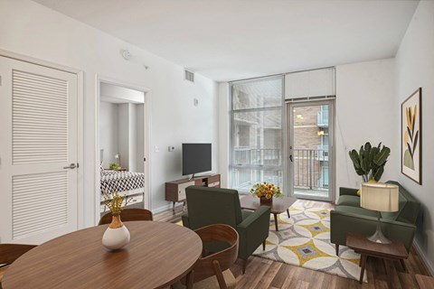 A living room with a wooden table and green chairs.