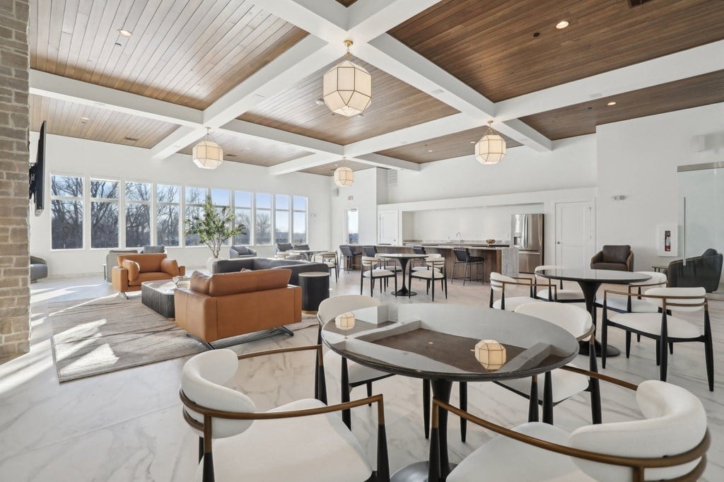 A modern living room with a wooden ceiling and a large window.