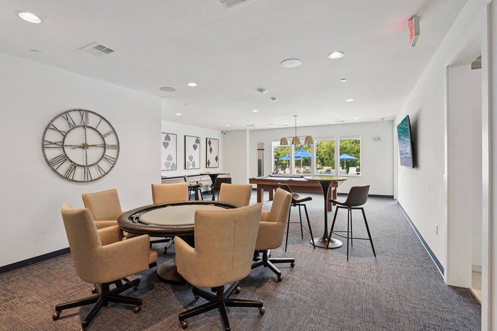 A conference room with a large table and chairs.