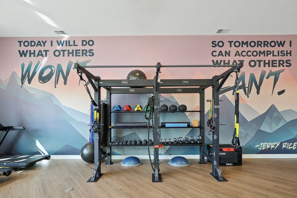 A gym with a wall mural that says "Today I will do what others won't. So tomorrow I can accomplish what others can't."