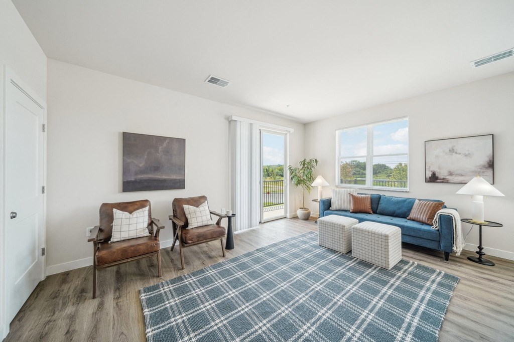 a living room with a blue couch and two chairs