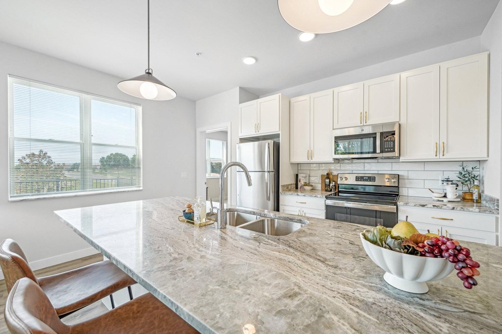 a kitchen with a marble counter top and a sink