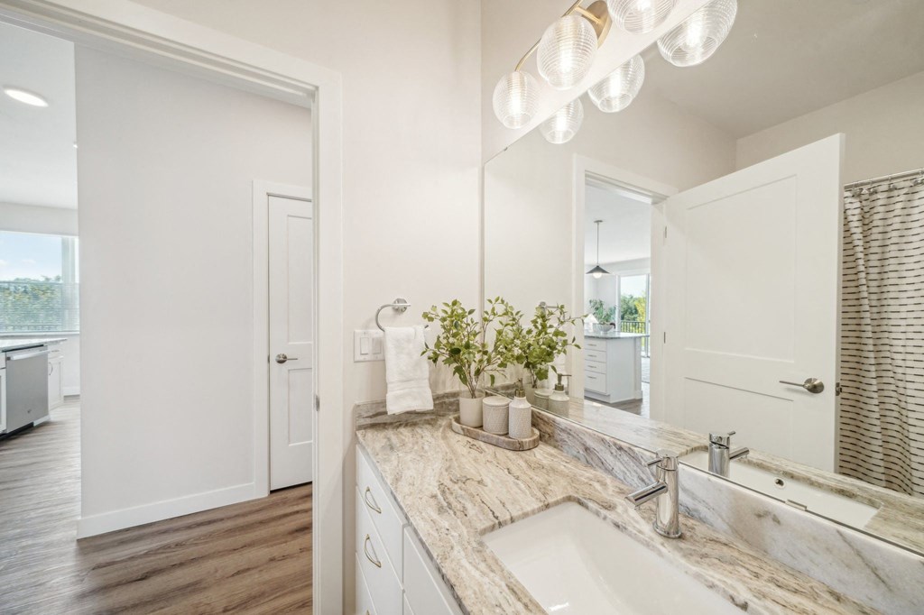 a white bathroom with a sink and a mirror