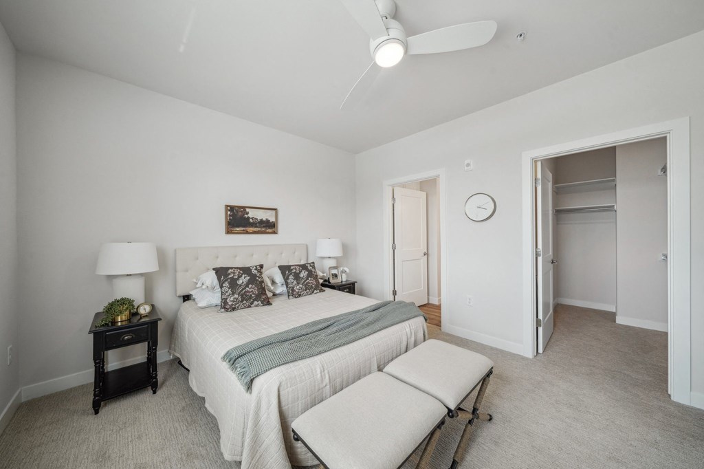 a bedroom with a large bed and a ceiling fan