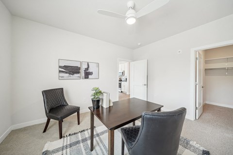 a dining room with a wooden table and chairs