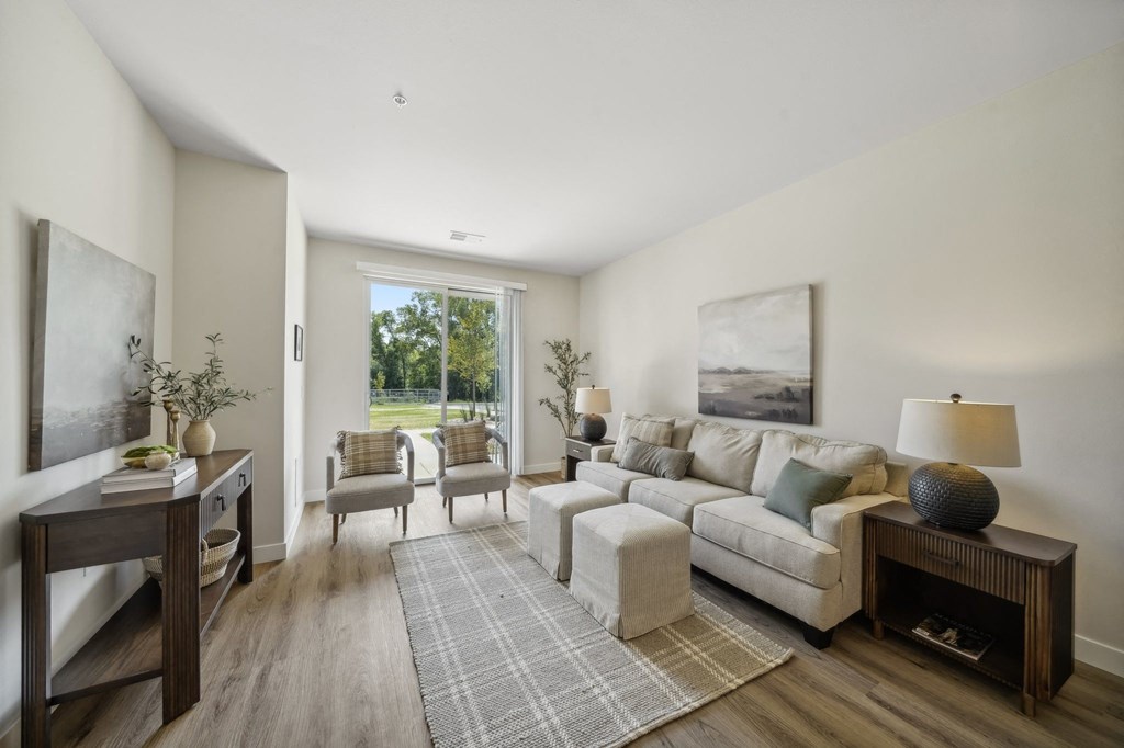 a living room with a couch and chairs and a table