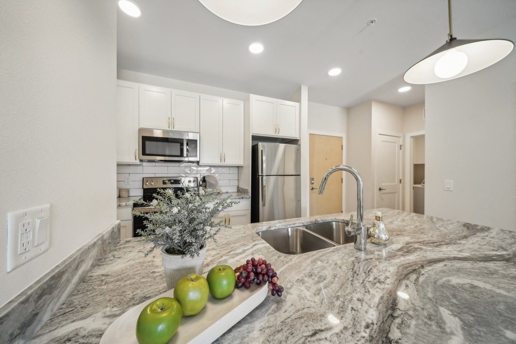 a kitchen with granite counter tops and a sink