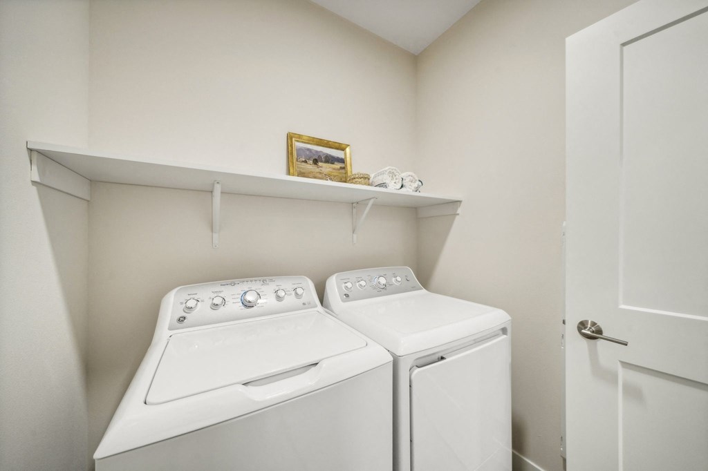 a washer and dryer in a laundry room with a white door