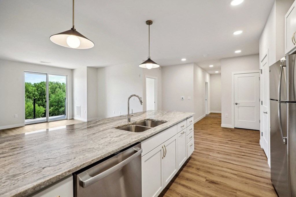 a large kitchen with a sink and a counter top