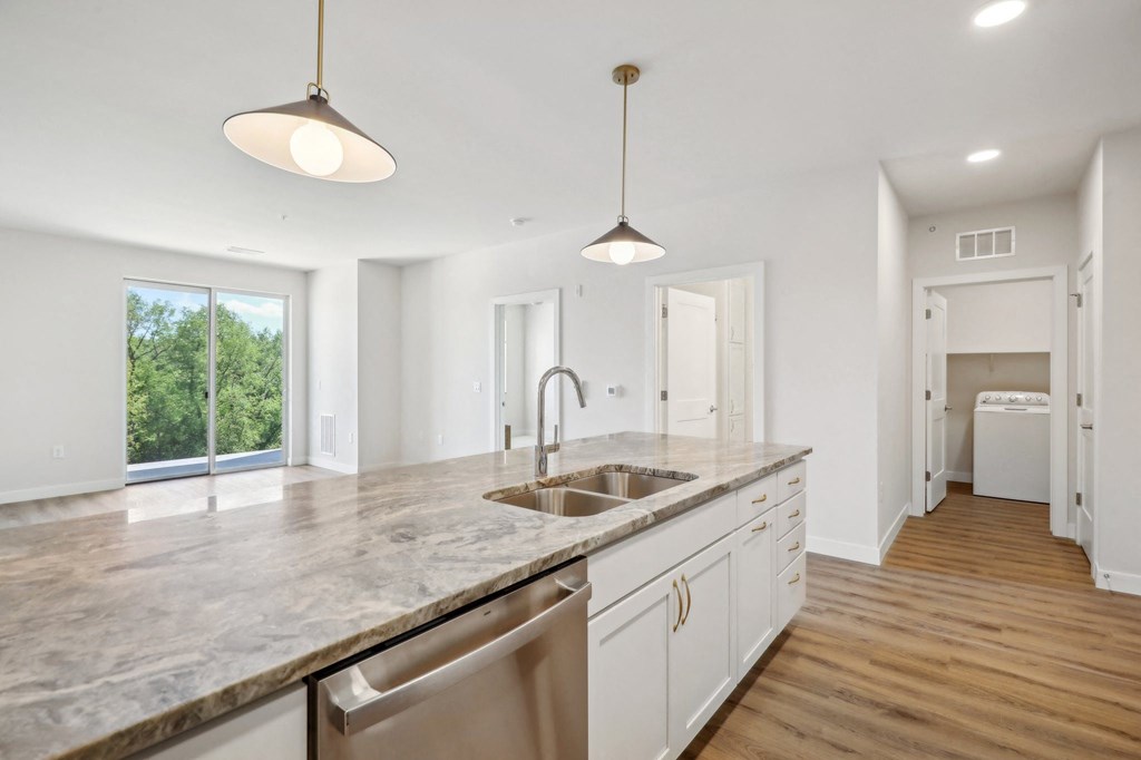 a large kitchen with a sink and a counter top