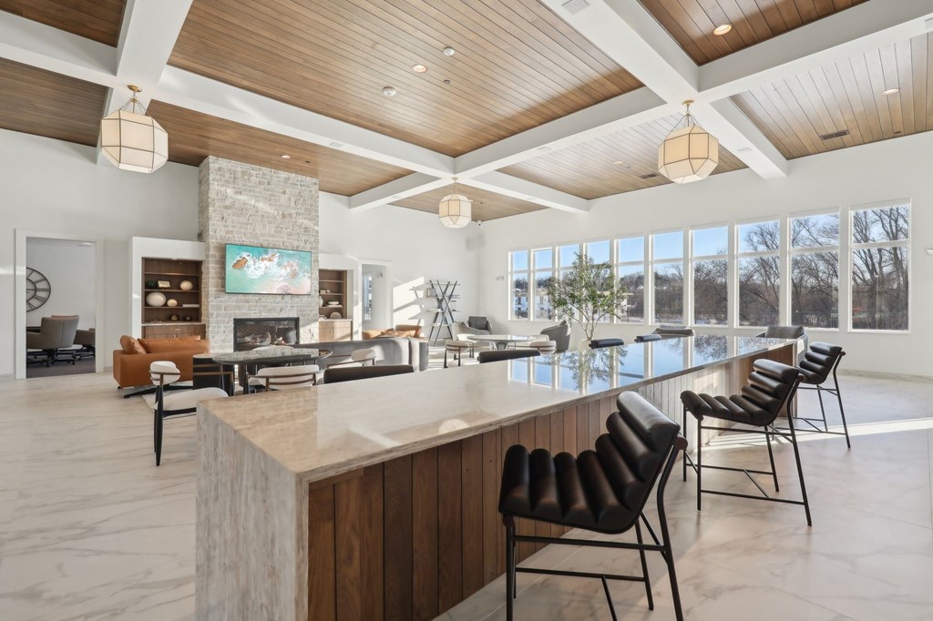A modern living room with a bar area and a fireplace.