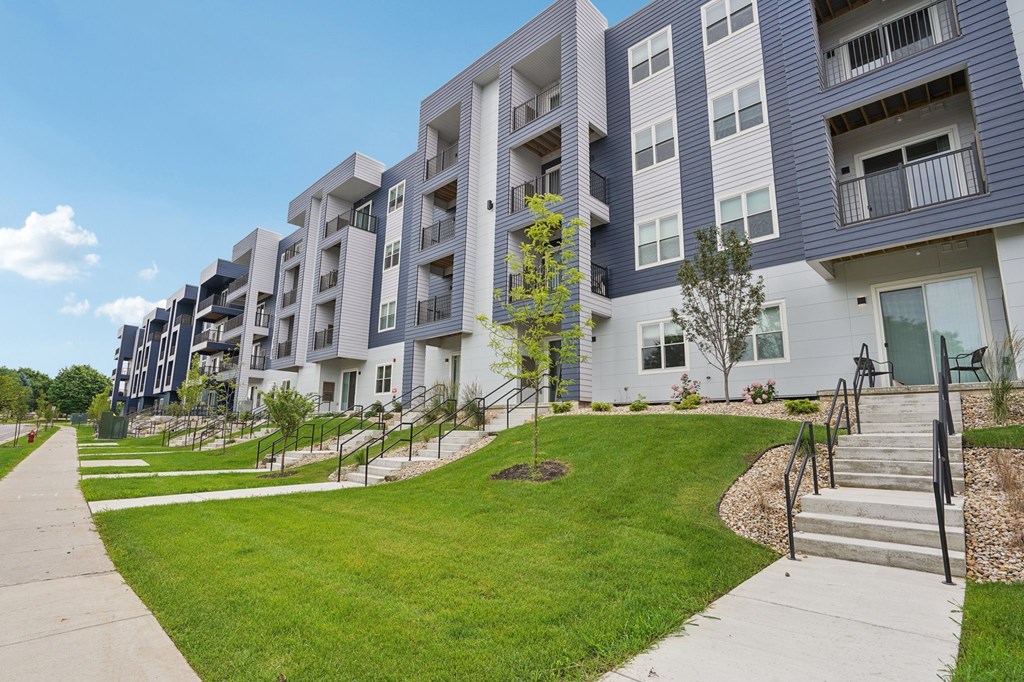 Apartment complex with a green lawn in front.