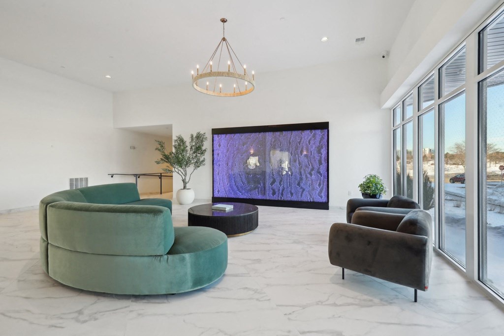 A living room with a green chair and a purple screen.