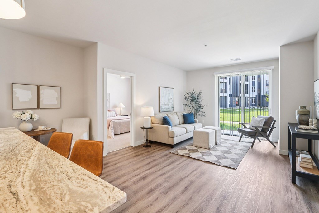 A well-lit, spacious living room with a large bed and a sofa.