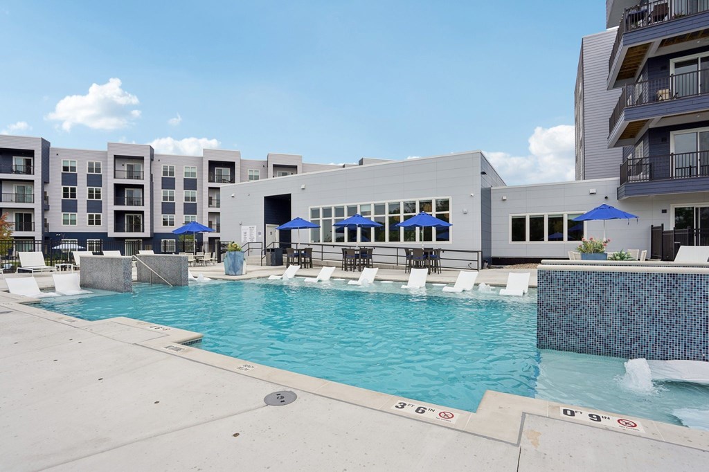 A swimming pool with a building in the background.