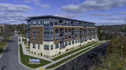 an aerial view of an apartment building on a city street