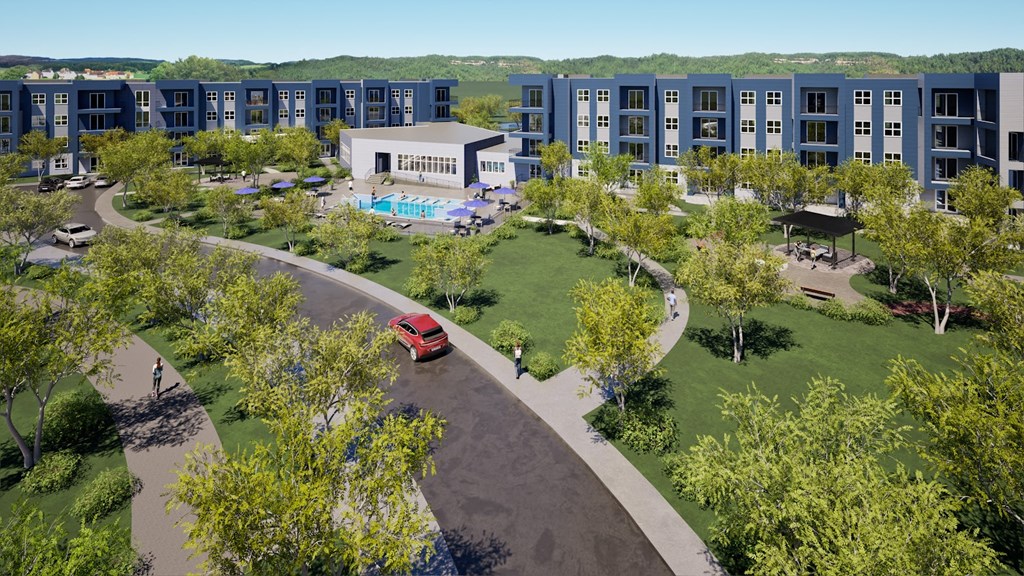 an aerial view of an apartment building with a red car parked in front of it