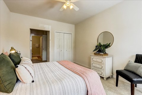 a bedroom with a bed and a mirror
