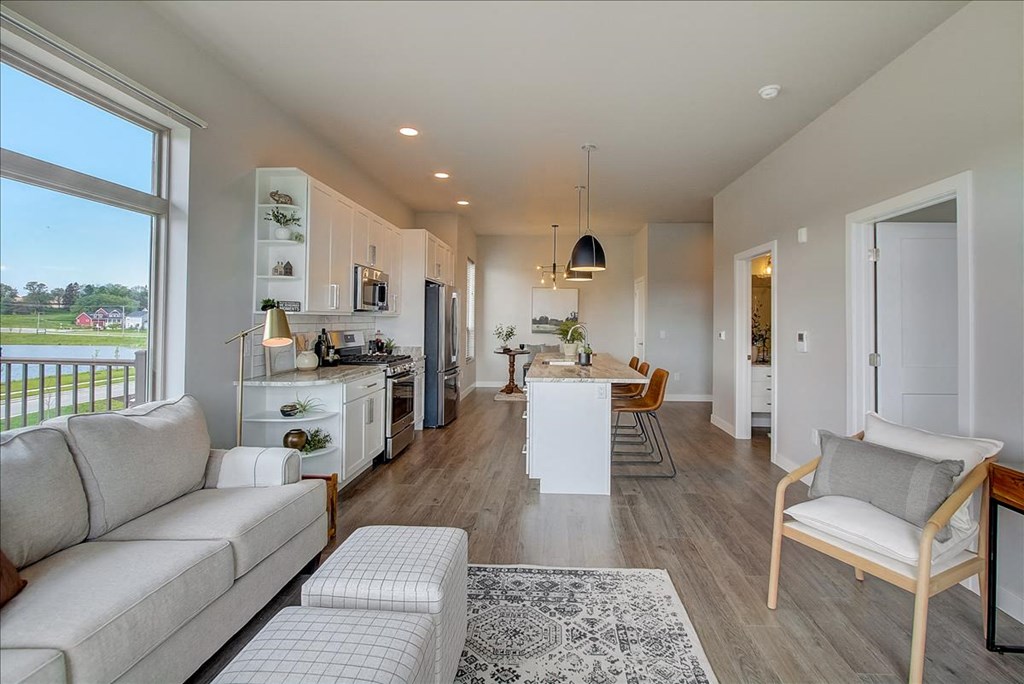 a living room and kitchen with a couch and a table