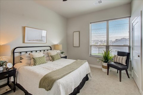 a bedroom with a bed and a window