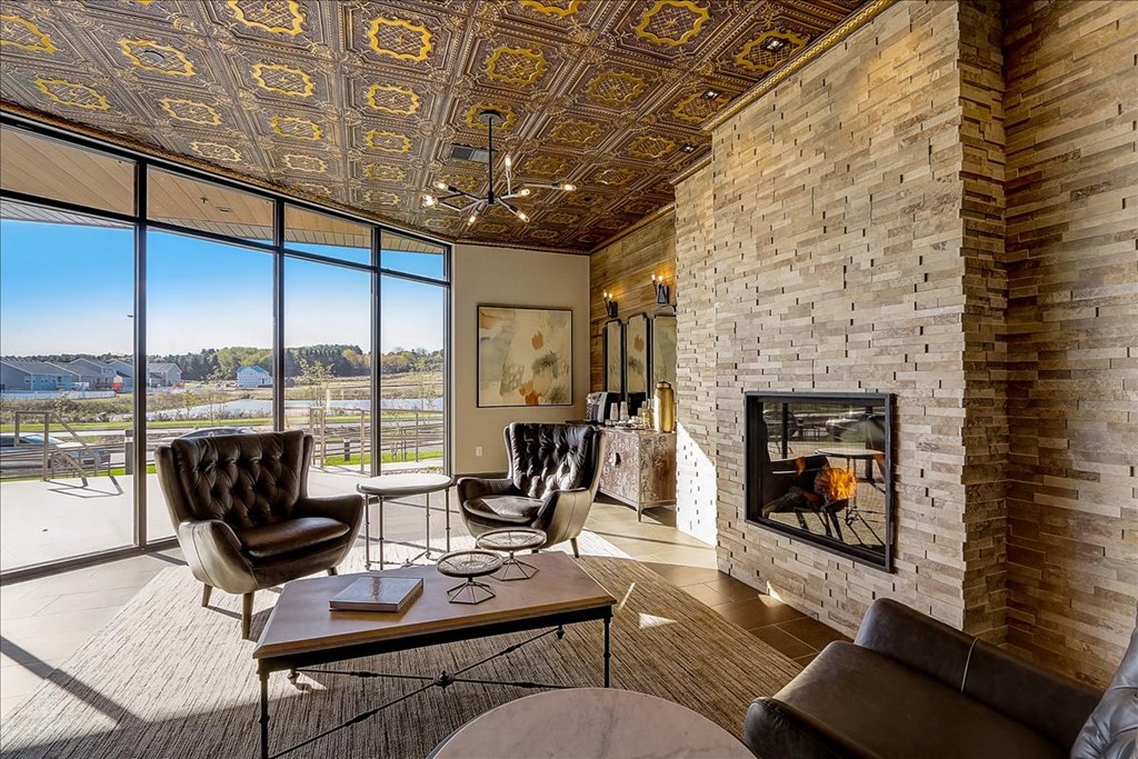 the living room has a fireplace and views of the river