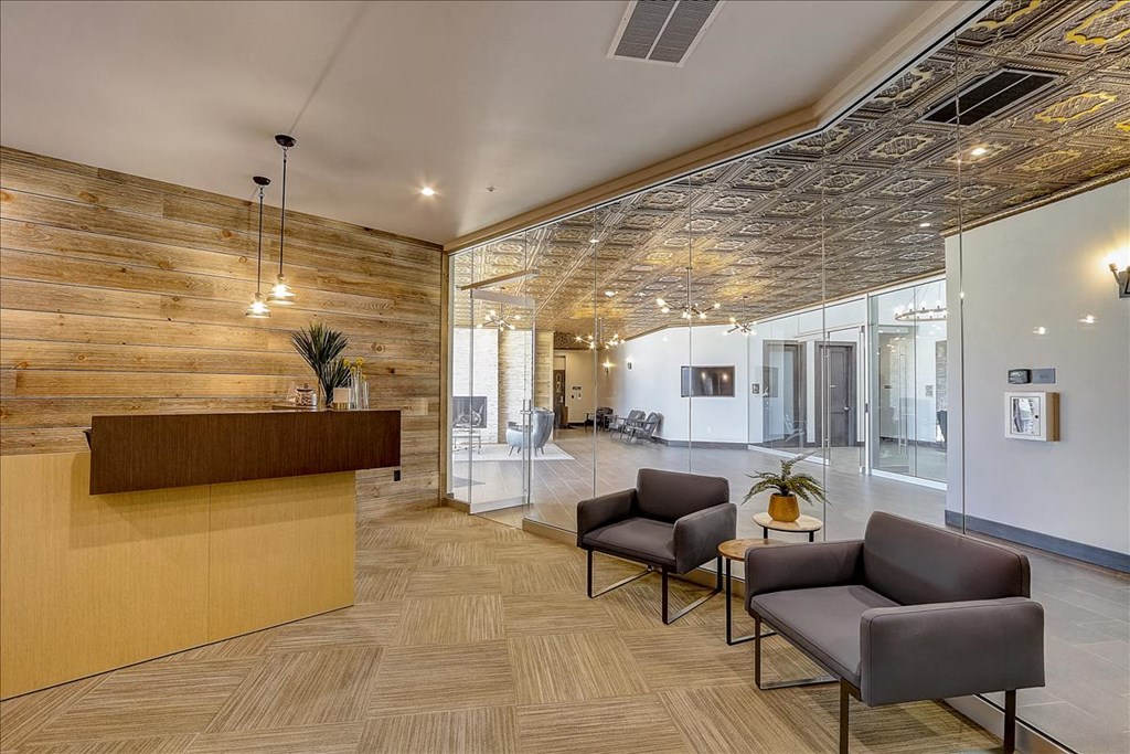 a lobby with chairs and a reception desk