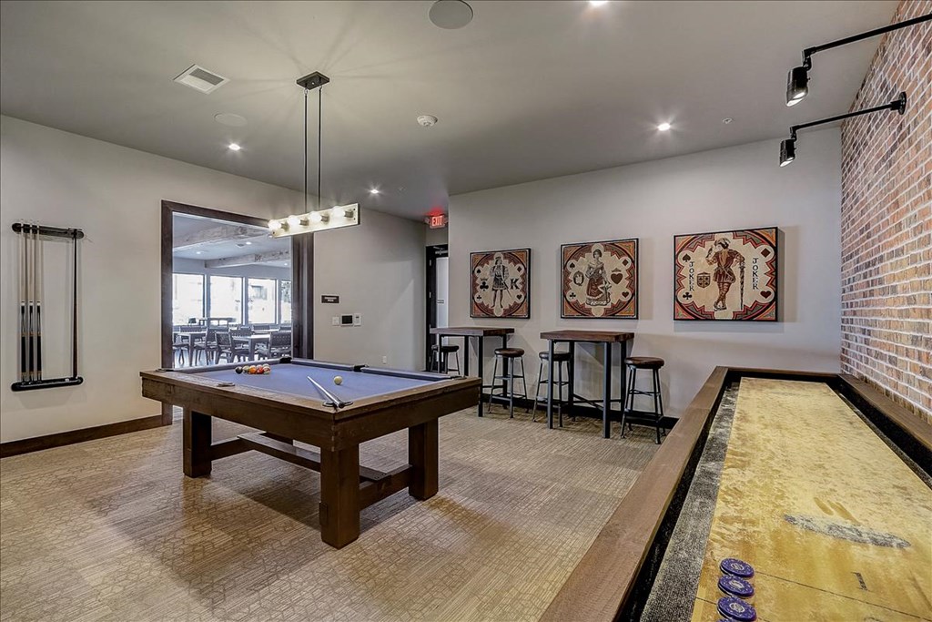 a game room with a pool table and a bar