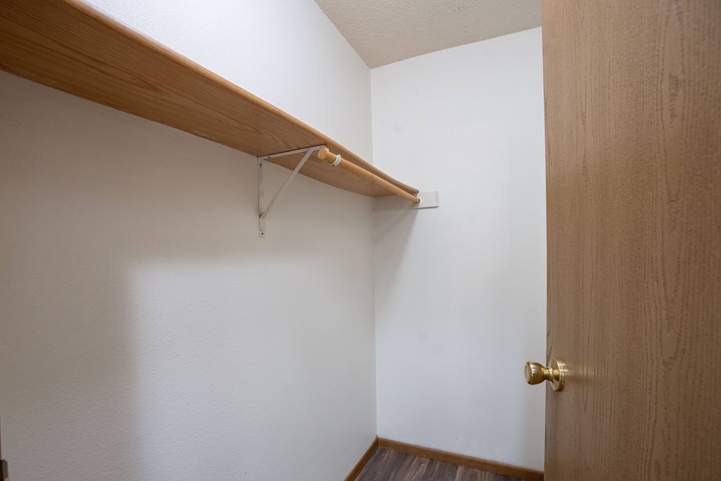 a closet with a shelf. Fargo, ND Country Edge Apartments