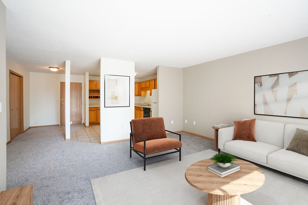 A living room with a brown chair and a white couch.