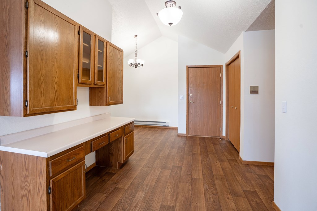 A desk with wooden cabinets and a white top. Fargo, ND Somerset Apartments