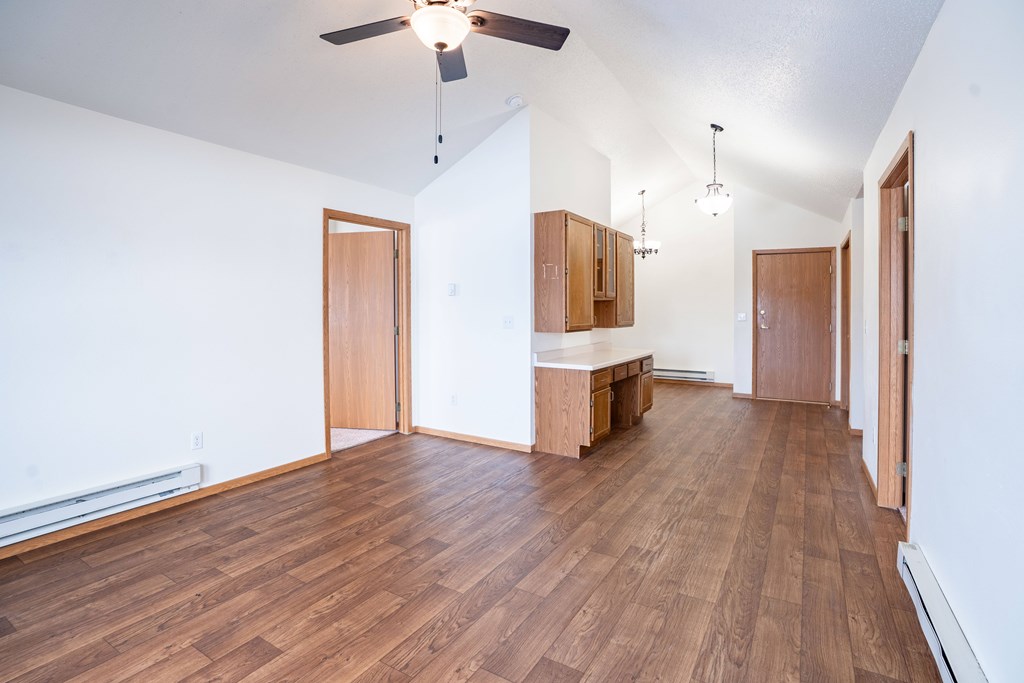 A room with wooden floors and a ceiling fan. Fargo, ND Somerset Apartments