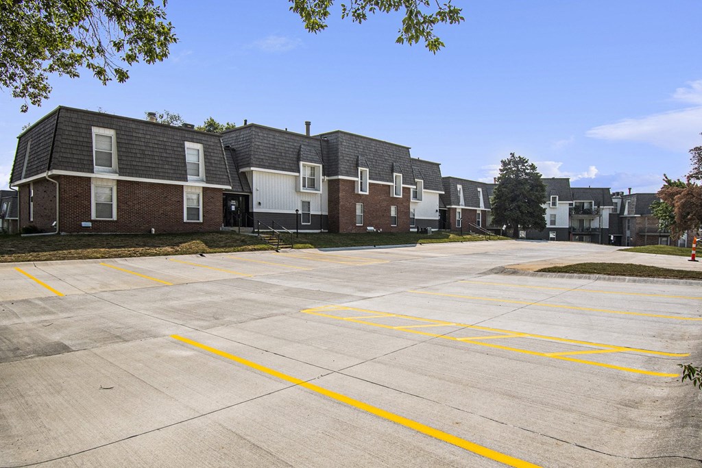 Omaha, NE Beacon Hill Apartments. A parking lot with a row of apartments in the background