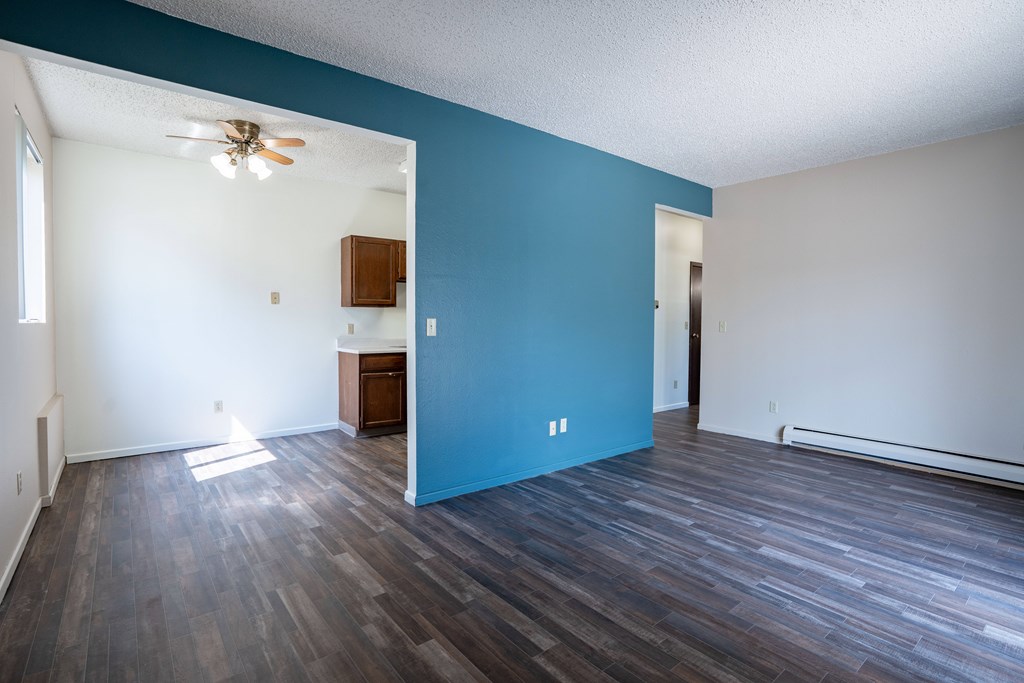 A room with a ceiling fan and a wooden cabinet. Bismarck, ND Belmont Apartments